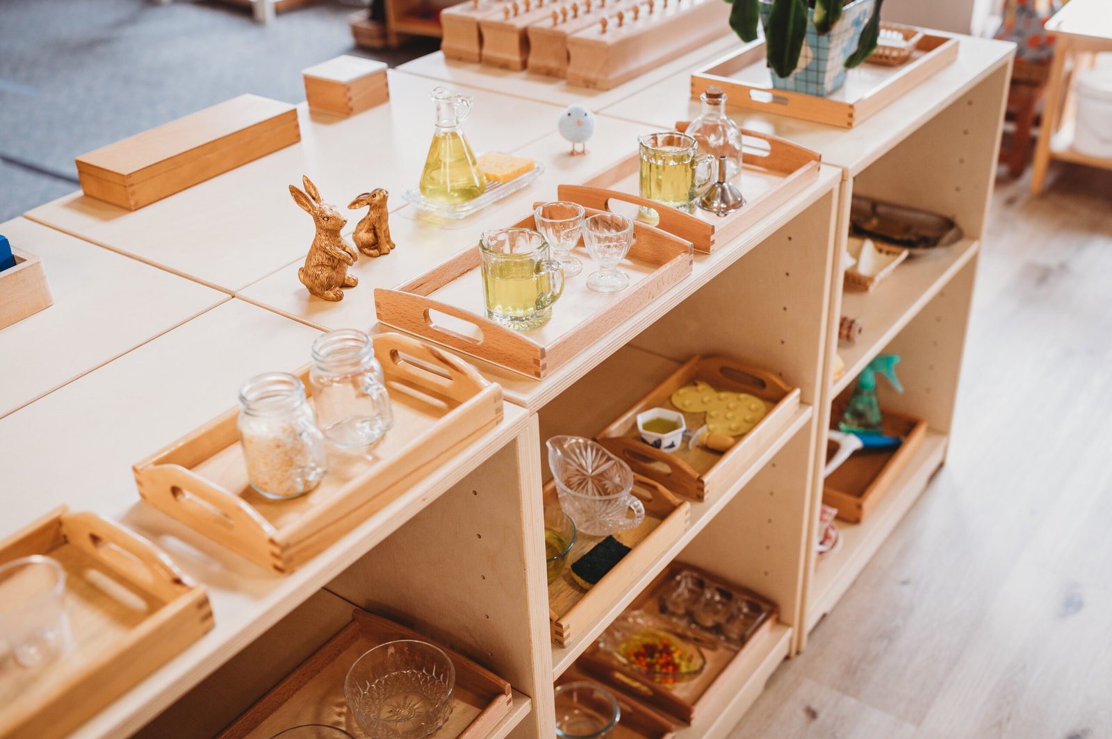 W Montessori Academy Elmhurst — teacher guiding child with Montessori materials