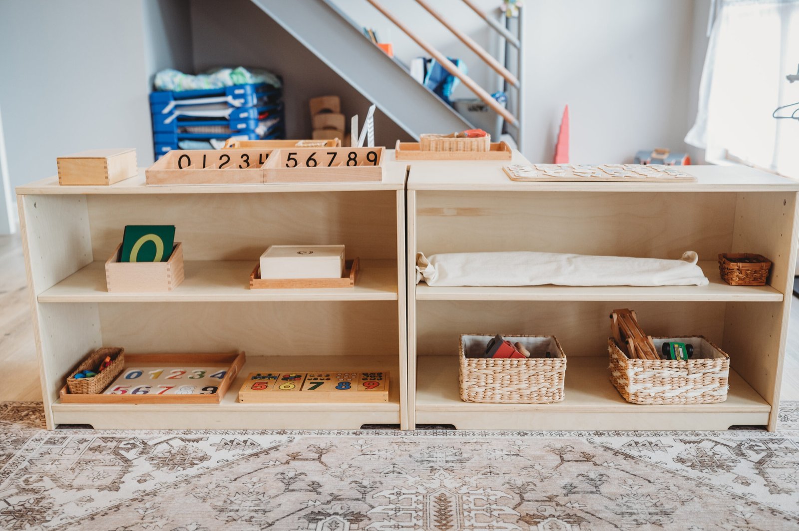 Organized Montessori classroom shelves with natural wood materials, plants, and carefully arranged learning activities